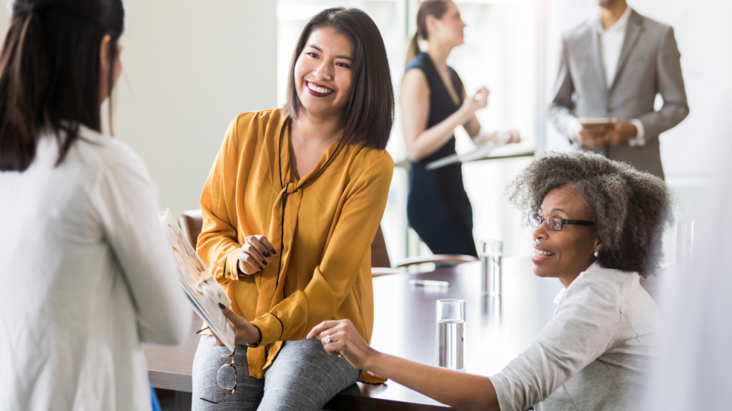 Dual Home Swellings - Image of Smiling women consulting an expert for guidance