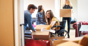 Disable women unpacking household things to decorate their new NDIS property